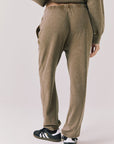 Back view of woman wearing Chaser’s Ginger Brown Manhattan Joggers on a white background