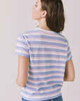 Back view of woman wearing Chaser’s Cosmo Pink Stripes Tee with pink stripe detailing on a white background