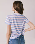 Back view of woman wearing Chaser’s Gimlet Pastel Stripe Tee on a plain background