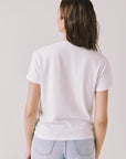 Back view of woman wearing Chaser’s Gimlet White Tee on a plain background
