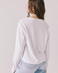 Back view of woman wearing Chaser’s Whiskey White Long Sleeve on a plain background