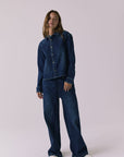 Chaser All Day Indigo Wash Button Down in Indigo Wash captured in a full body studio frame styled with wide leg denim for a relaxed look