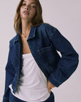 Mid-body view of the Chaser Sutton Indigo Wash Jacket showing zipper hardware and pocket stitching