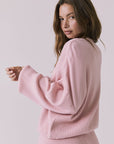 Three-quarter view of the Chaser Rhode Pink Salt Pullover showing the draped fit and wide sleeves