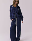 Chaser Abilene Sapphire Zip Up styled with matching Sandi Sapphire Joggers in a full body studio frame