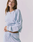 Chaser Campbell Bluebird Pullover detail view focusing on the ribbed cuffs, neckline trim, and soft brushed fabric texture