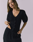 Chaser Abbie Black Blouse in a mid shot highlighting the button front and puff sleeves
