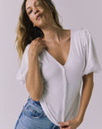 Front detail of the Abbie White Blouse with soft ruching and puff sleeves