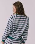 Back view of woman wearing Chaser's Resort Stripe Long Sleeve pullover sweater and matching shorts against a plain background