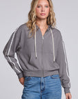 Model wearing Chaser's Soft Graphite Emily Zip-Up in Soft Graphite grey hooded zip-up with contrast sleeve stripes, front view