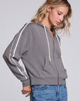 Model wearing Chaser's Soft Graphite Emily Zip-Up in Soft Graphite grey hooded zip-up with contrast sleeve stripes, angled view