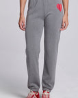 Model wearing Chaser's Dual Tone Heart Jogger in Streaky with a single red heart, front view