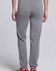 Model wearing Chaser's Dual Tone Heart Jogger in Streaky with a single red heart, back view