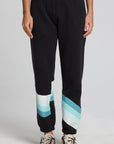 Front view of a woman wearing the Chaser Ada Black Jogger on a neutral background with arms at sides