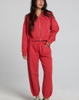 Full body front view of a woman wearing the Chaser Ada Dry Red Jogger on a neutral background