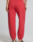 Back view of a woman wearing the Chaser Ada Dry Red Jogger on a neutral background with arms at sides and brown sneakers
