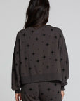 Back view of a woman wearing the Chaser Chaser Allover Mini Stars Long Sleeve and matching pants on a neutral background