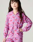 Front view of a girl wearing the Chaser Allover Sweethearts Girls Hoodie on a neutral background with matching pink pants