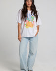 A full body front view of a woman wearing the Chaser Bagged Italy Tee on a neutral background