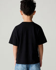 Back view of a boy wearing the Chaser Basketball Boys Tee on a neutral background and jeans