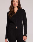 Front view of a woman wearing the Chaser Beatrix Black Sweater on a neutral background with matching pants