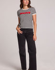 A full body front view of a woman wearing the Chaser Bisous Tee on a neutral background