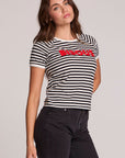Side angle view of a woman wearing the Chaser Bisous Tee on a neutral background with black pants