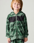 Font view of a boy wearing the Chaser Blocked Camo Boys Hoodie on a neutral background with matching pants