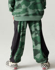 Back view of a boy wearing the Chaser Blocked Camo Pants Boys Jogger on a neutral background
