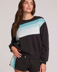 Front view of a woman wearing the Chaser Cashbah Black Pullover on a neutral background