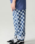 Side view of a boy wearing the Chaser Checkered Pants Boys Jogger on a neutral background