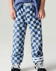 Front view of a boy wearing the Chaser Checkered Pants Boys Jogger on a neutral background with matching shirt