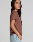 Back view of a woman wearing the Chaser Cute Buttired Top on a neutral background with jeans