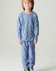 A full body front view of a boy wearing the Chaser Dino Bolts Boys Tee on a neutral background