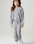 Front view of a girl wearing the Chaser Ditsy Hearts Girls Jogger matching set on a neutral background
