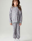 A full body front view of a girl wearing the Chaser Ditsy Hearts Girls Tee on a neutral background