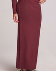 Front view of a girl wearing the Chaser Eloyse Brick Red Skirt on a neutral background with matching top