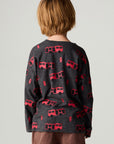 Back view of a boy wearing the Chaser Fire Trucks Boys Tee on a neutral background with arms lowered