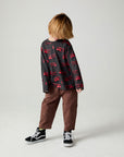 A full body front view of a boy wearing the Chaser Fire Trucks Boys Tee on a neutral background