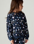 Front view of a girl wearing the Chaser Free Draw Girls Tee on a neutral background looking to one side