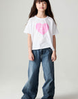 A full body front view of a girl wearing the Chaser Full Of Love Girls Tee on a neutral background