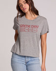 Front view of a woman wearing the Chaser Game Days Graphic Tee on a neutral background