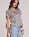 Side angle view of a woman wearing the Chaser Game Days Graphic Tee and jeans on a neutral background