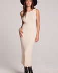 Side view of a woman wearing the Chaser Gracelyn Antique White Dress on a neutral background with black hat and shoes