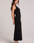 Side view of a woman wearing the Chaser Gracelyn Black Dress on a neutral background with loafers