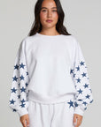 Front view of a woman wearing the Chaser High Spirits Long Sleeve on a neutral background with matching pants