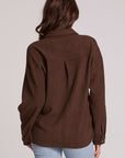 Back view of a woman wearing the Chaser Jaxxon Wood Brown Shacket on a neutral background with arms at sides