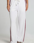 Front view of a woman wearing the Chaser Jessee Cloud White Trackpants on a neutral background with arms down at sides