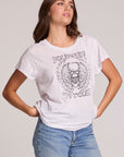 Front view of a woman wearing the Chaser Journey 79 Tour Tee on a neutral background with hands on her hips