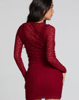 Back view of a woman wearing the Chaser Kevin Deep Berry Longsleeve on a neutral background with skirt